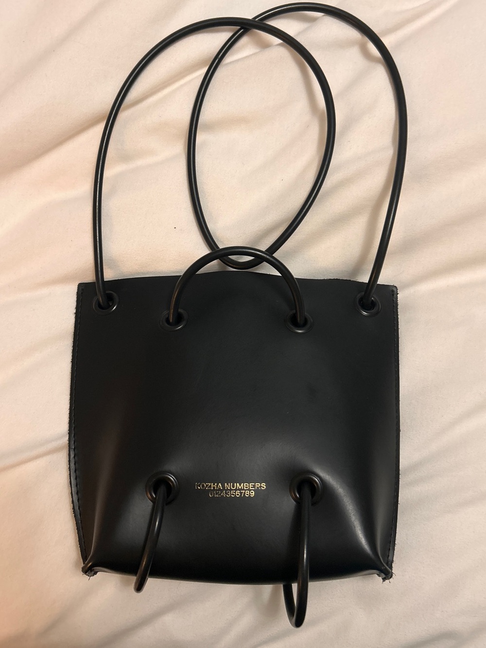 Kozha Numbers handcrafted calf leather shoulder bag
